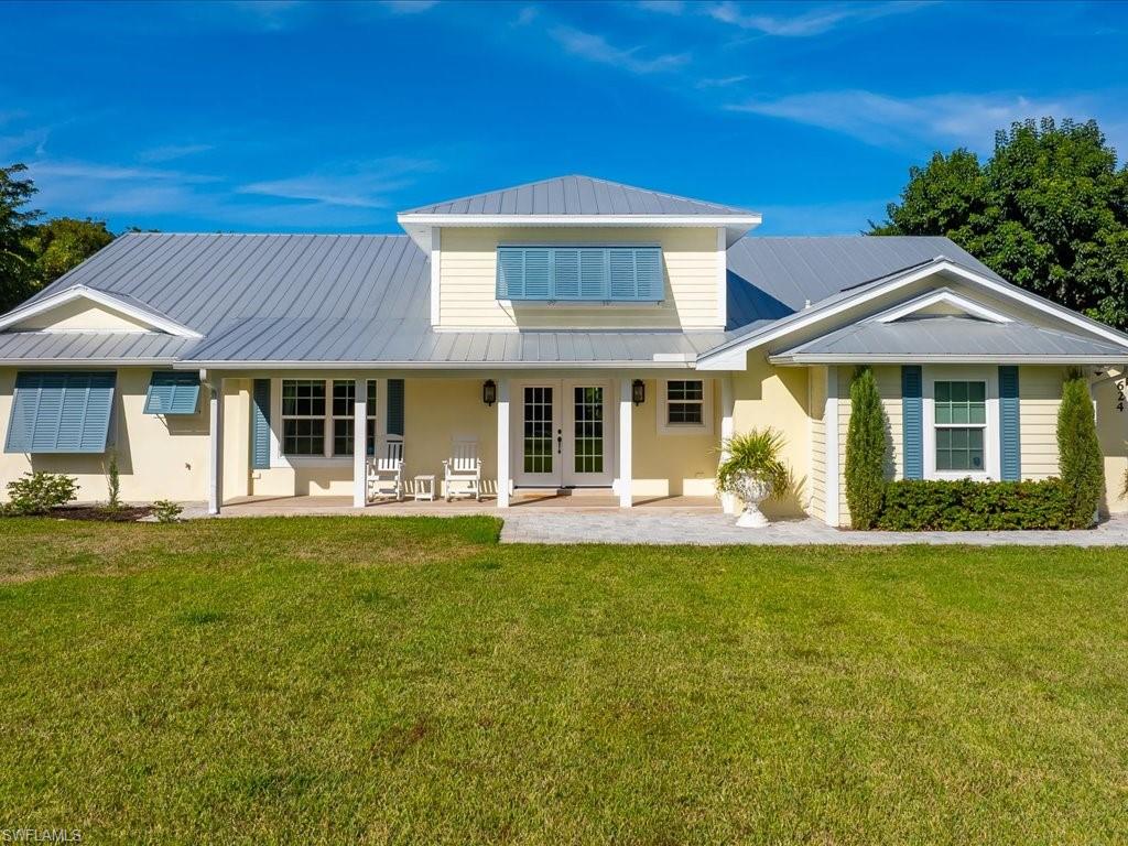 624 Ridge Drive Naples, FL 34108 - Photo 49 of 50 a front view of a house with a garden