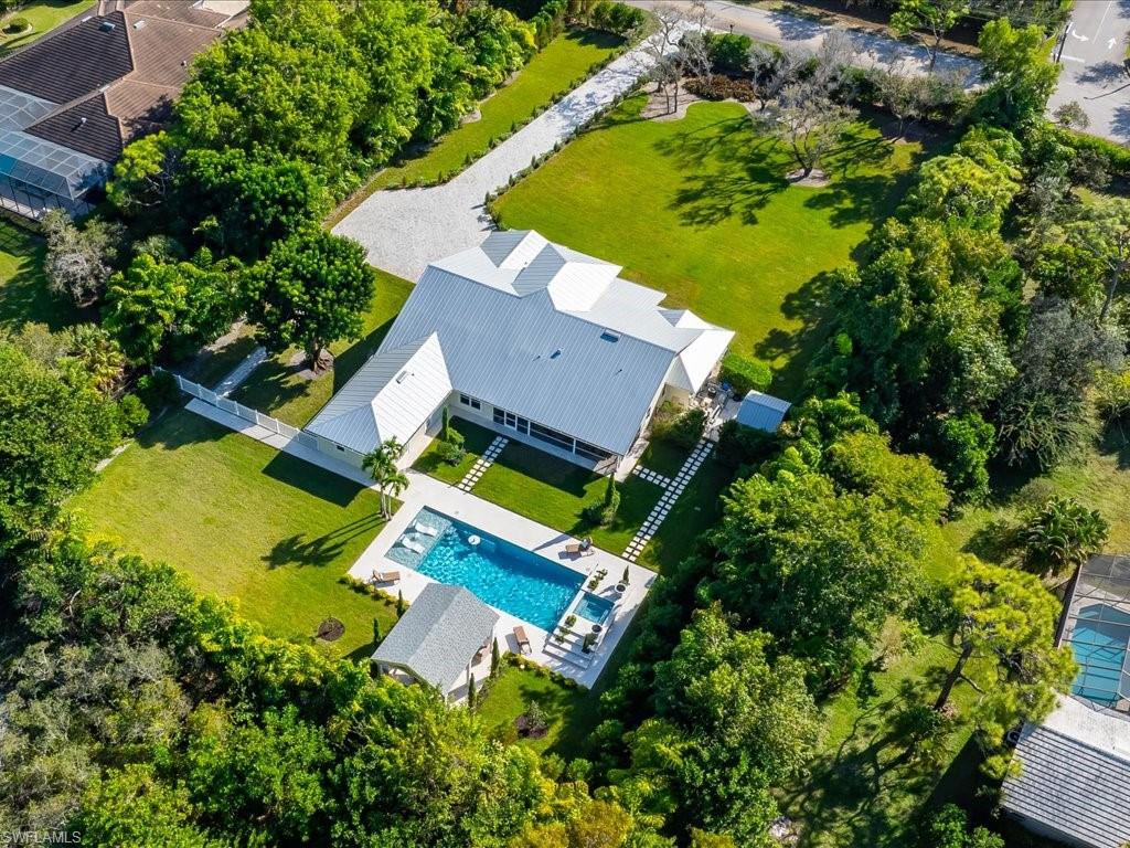 624 Ridge Drive Naples, FL 34108 - Photo 50 of 50 an aerial view of a house with a garden and swimming pool