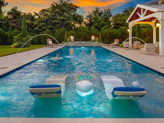 a view of a swimming pool with a yard