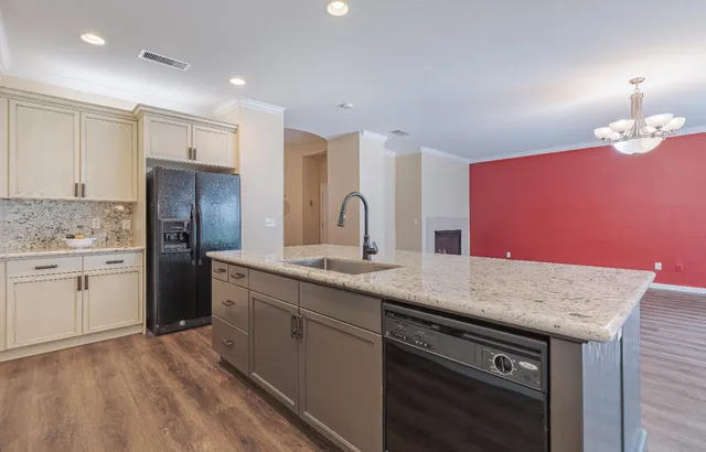 a kitchen with stainless steel appliances granite countertop a sink stove and refrigerator