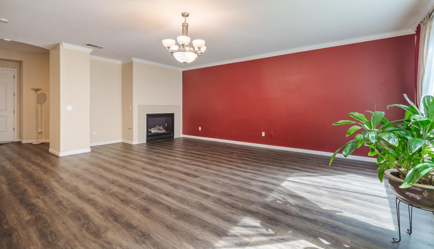 2222 Carson Avenue Clovis, CA 93611 - Photo 14 of 41 a view of a livingroom with wooden floor and a chandelier