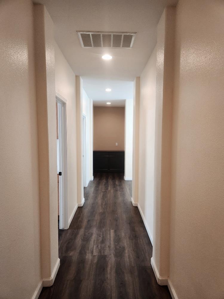 2222 Carson Avenue Clovis, CA 93611 - Photo 29 of 41 a view of a hallway with wooden floor