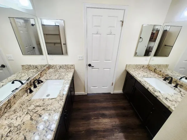 a bathroom with a double vanity sink and mirror