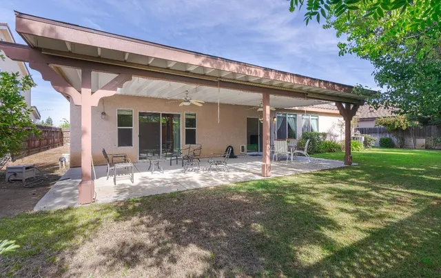 a view of a house with backyard porch and furniture
