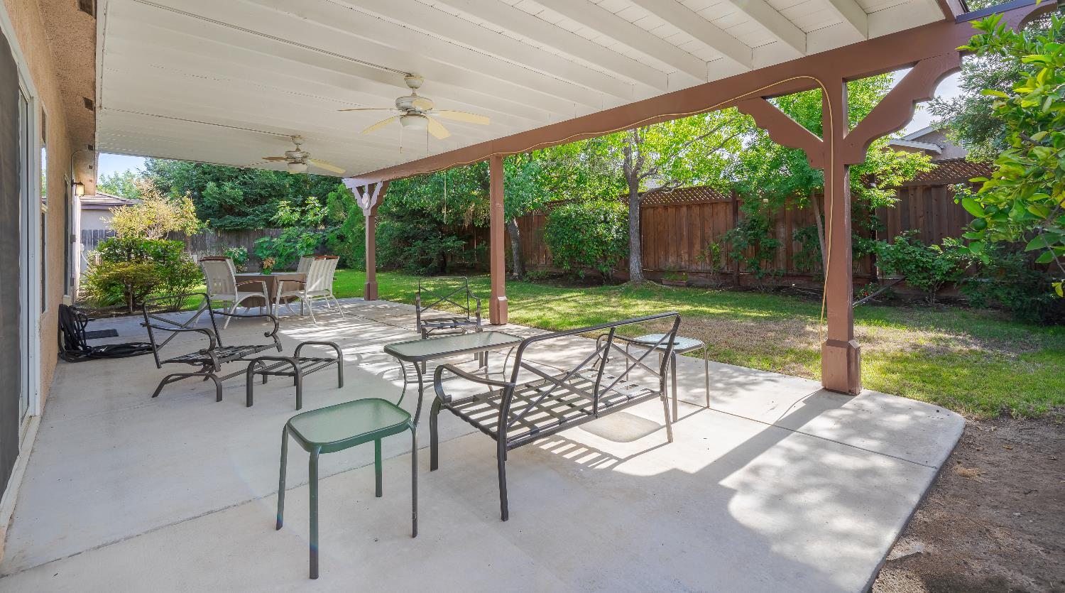 2222 Carson Avenue Clovis, CA 93611 - Photo 41 of 41 a view of a patio with a table chairs and a backyard