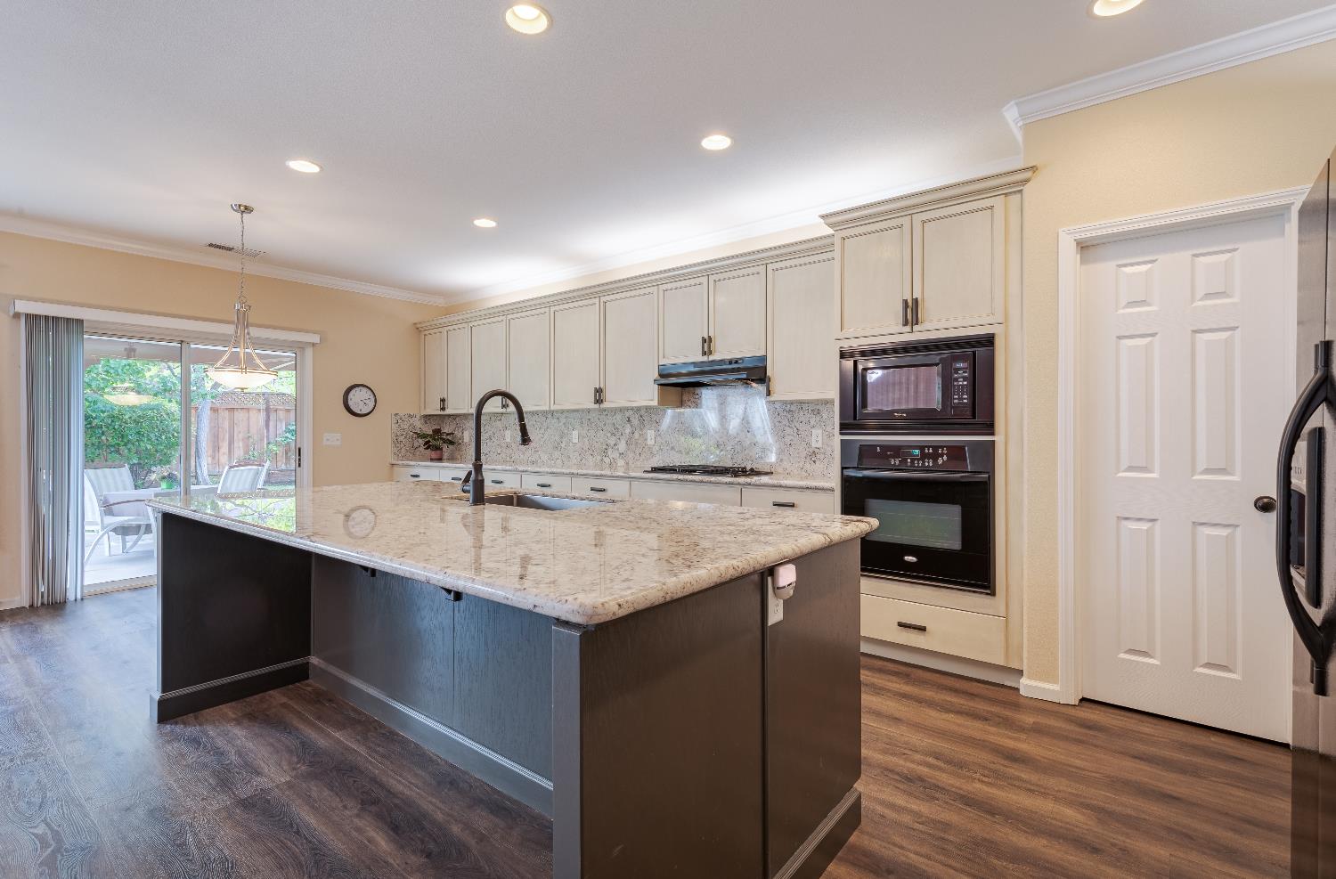 2222 Carson Avenue Clovis, CA 93611 - Photo 6 of 41 a kitchen with stainless steel appliances granite countertop a sink stove and refrigerator
