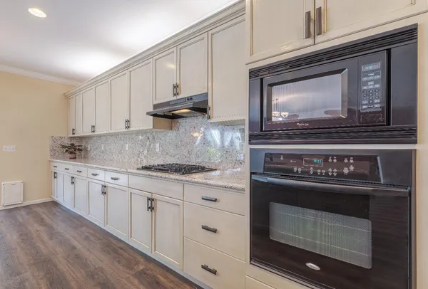 a stove top oven sitting inside of a kitchen