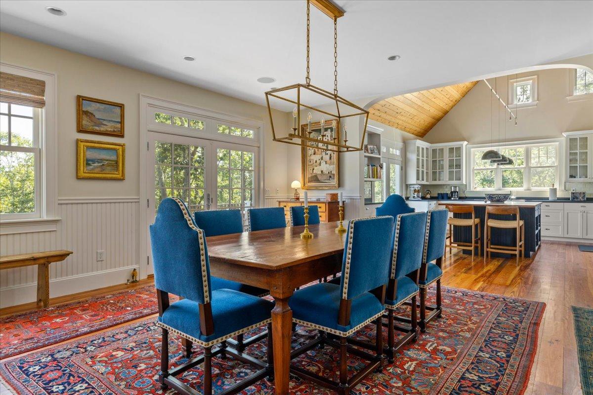 58 Slough Pond Road Truro, MA 02666 - Photo 16 of 82 a dining room with furniture a window and a chandelier