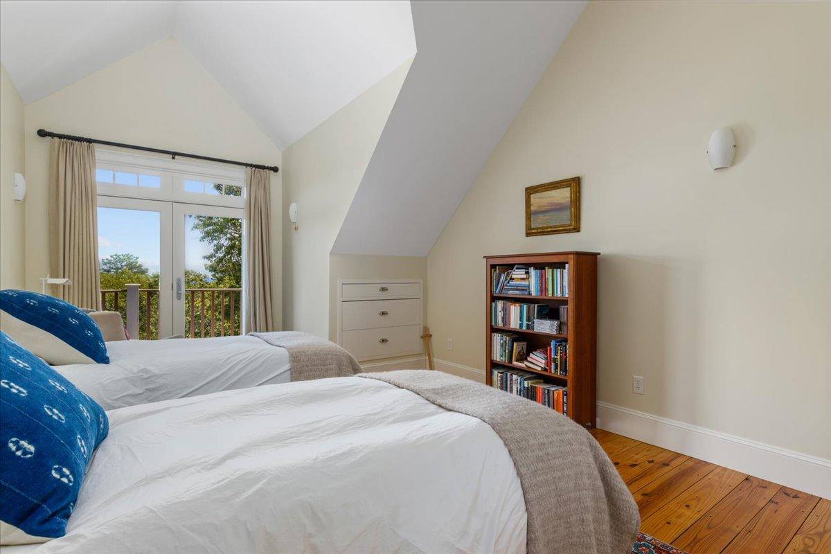 58 Slough Pond Road Truro, MA 02666 - Photo 44 of 82 a bedroom with a large bed and a book shelf