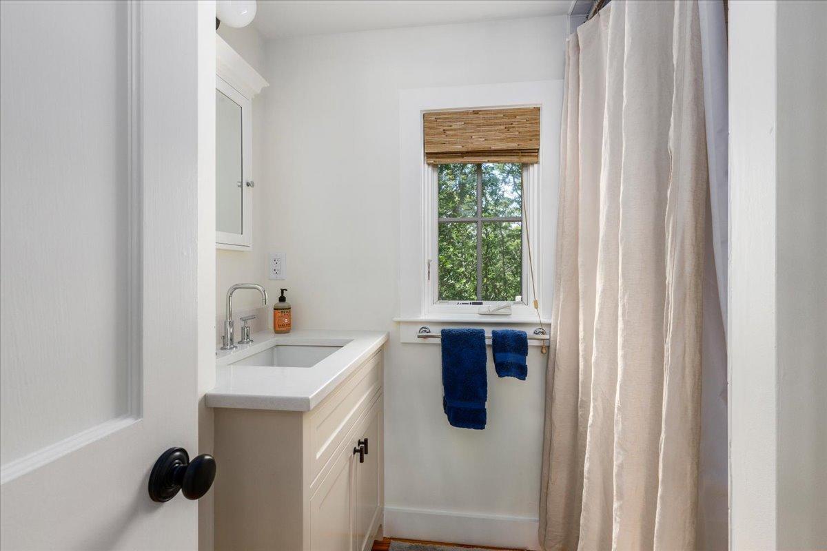 58 Slough Pond Road Truro, MA 02666 - Photo 57 of 82 a view of a bathroom with a sink and window