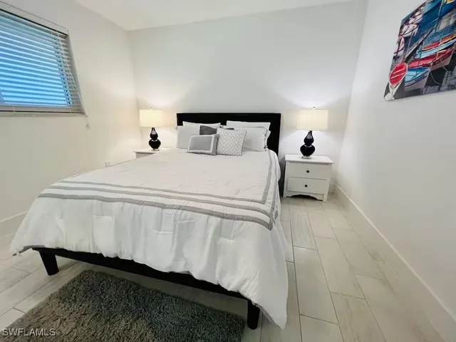 a bedroom with a bed and window