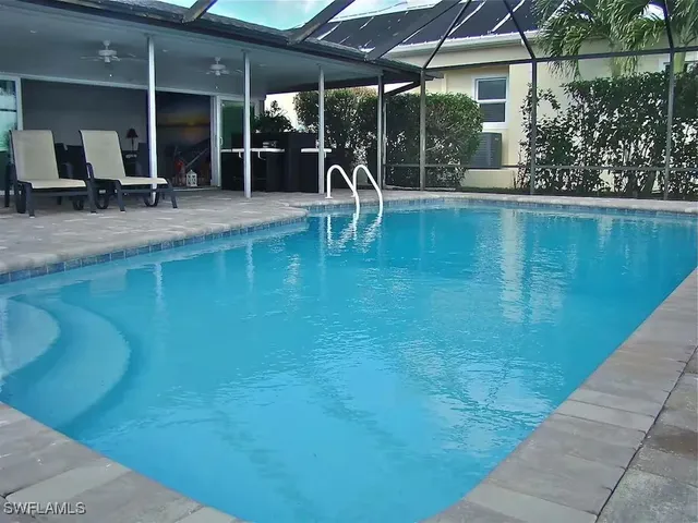 a swimming pool with outdoor seating and yard