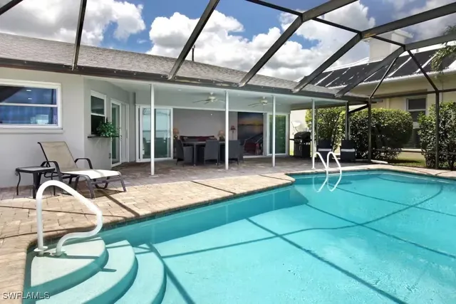 a view of a patio with table and chairs a barbeque with wooden fence