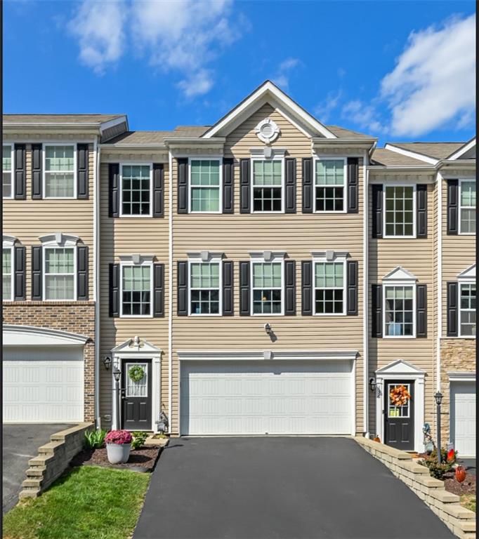 a front view of a residential apartment building with a yard
