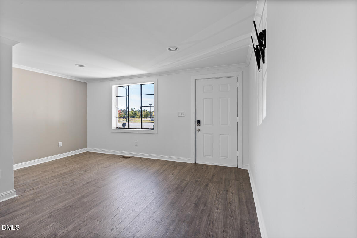7700 Humie Olive Road Apex, NC 27502 - Photo 4 of 13 wooden floor in an empty room with a window