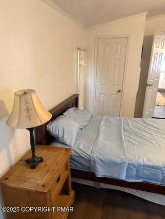 an empty room with a painting on the wall