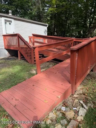 a view of a wooden deck with a yard