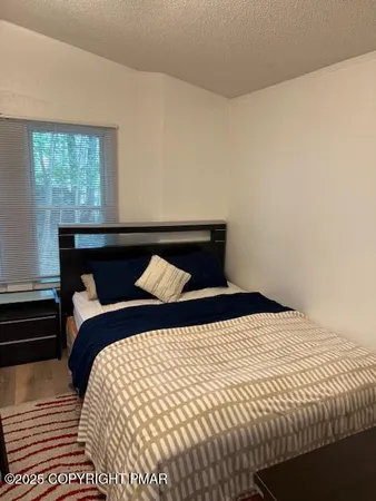 a bedroom with a bed and window