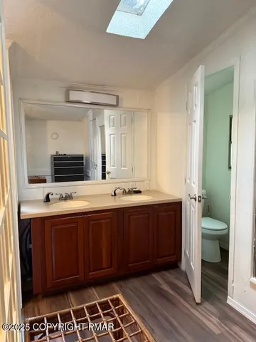 a large bathroom with a sink and a large mirror