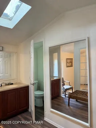 a white toilet sitting next to a small sink