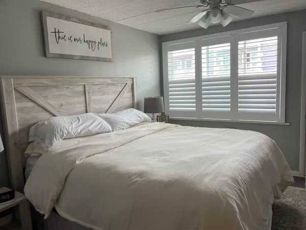 a bedroom with a bed and a television