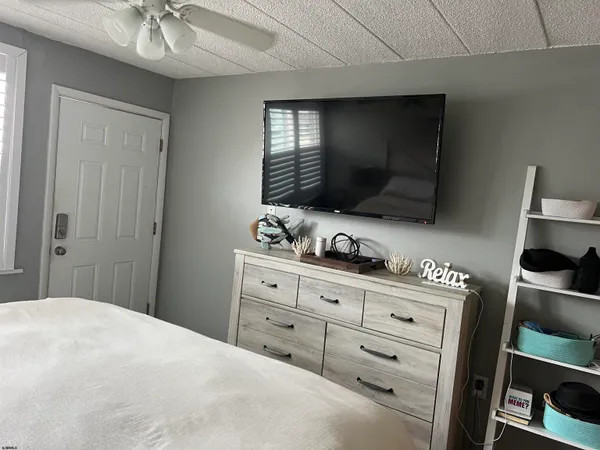 a bedroom with a bed and a television