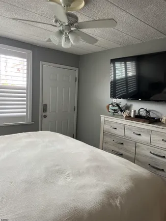 a bedroom with a bed and a mirror