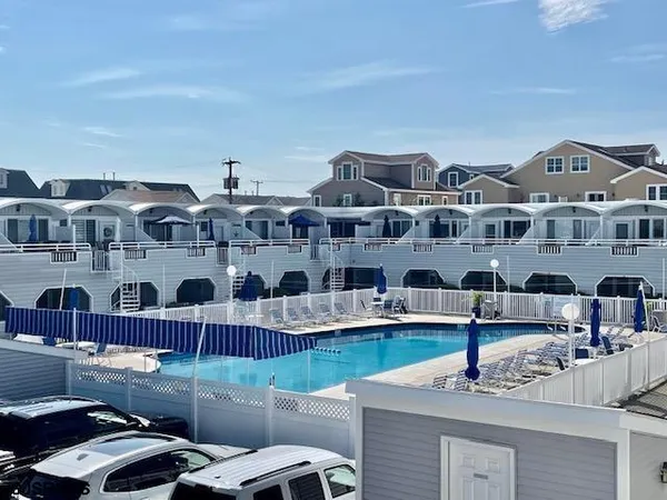 a front view of a building with glass top table and chairs