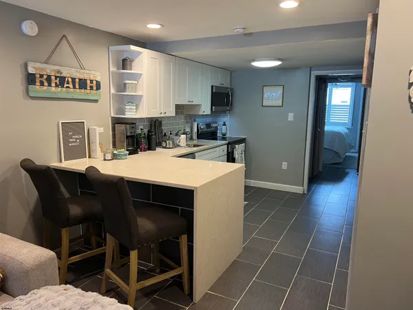 a kitchen with a sink a stove a microwave a counter top space and cabinets