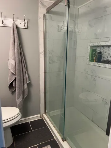 a large bed sitting in a bedroom next to a window