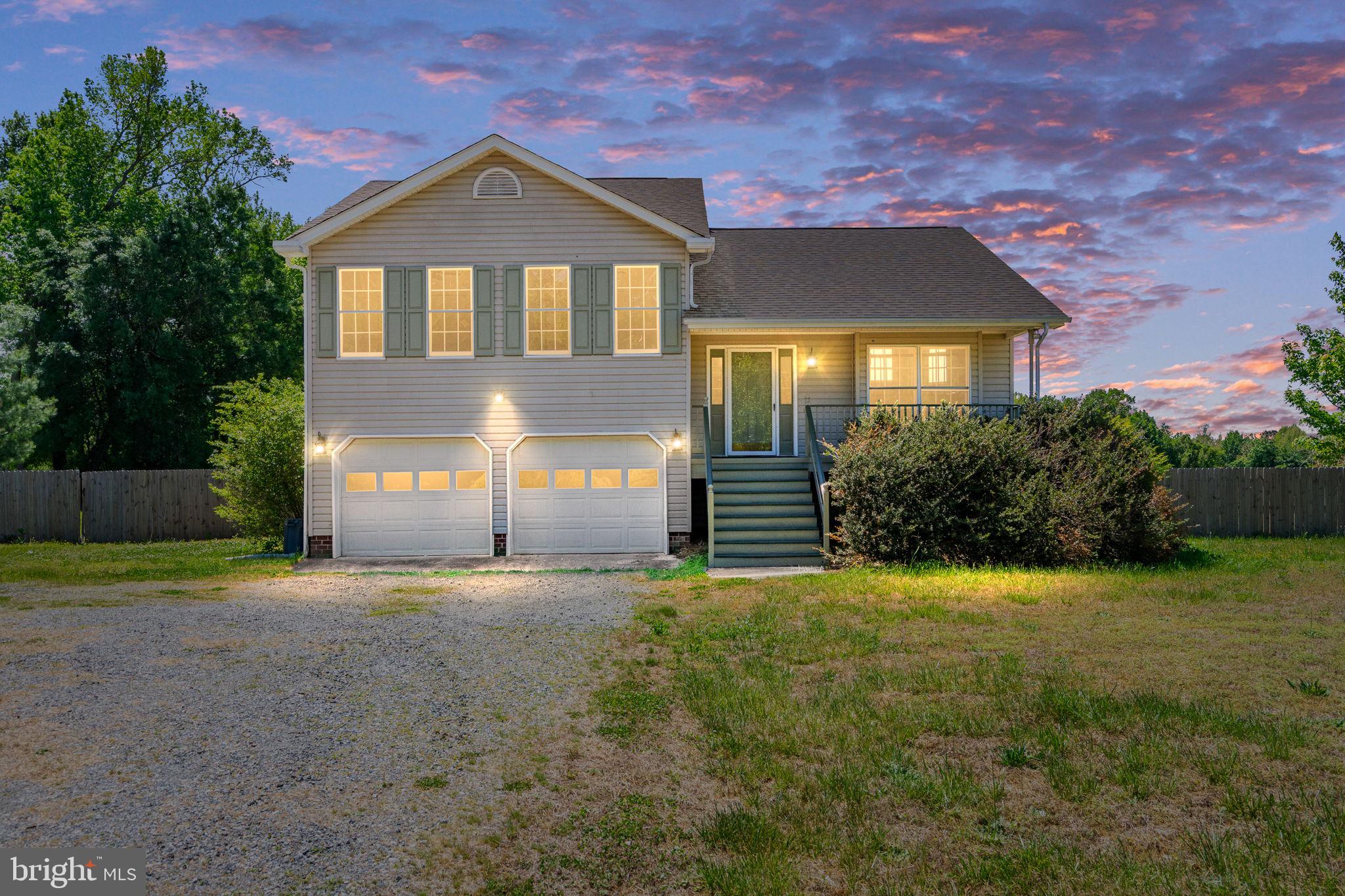16456 Antioch Road Milford, VA 22514 - Photo 1 of 27 a front view of a house with a yard and garage