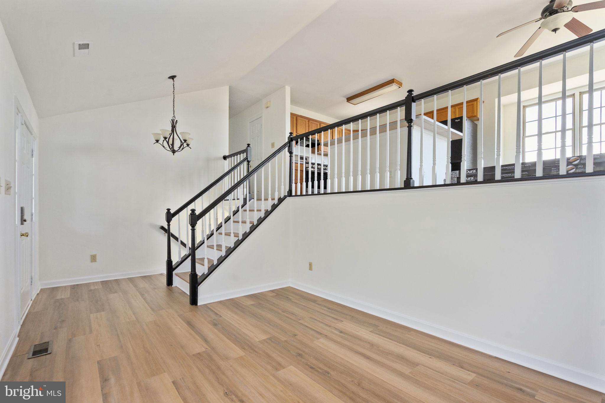 16456 Antioch Road Milford, VA 22514 - Photo 13 of 27 a view of staircase with wooden floor and white walls
