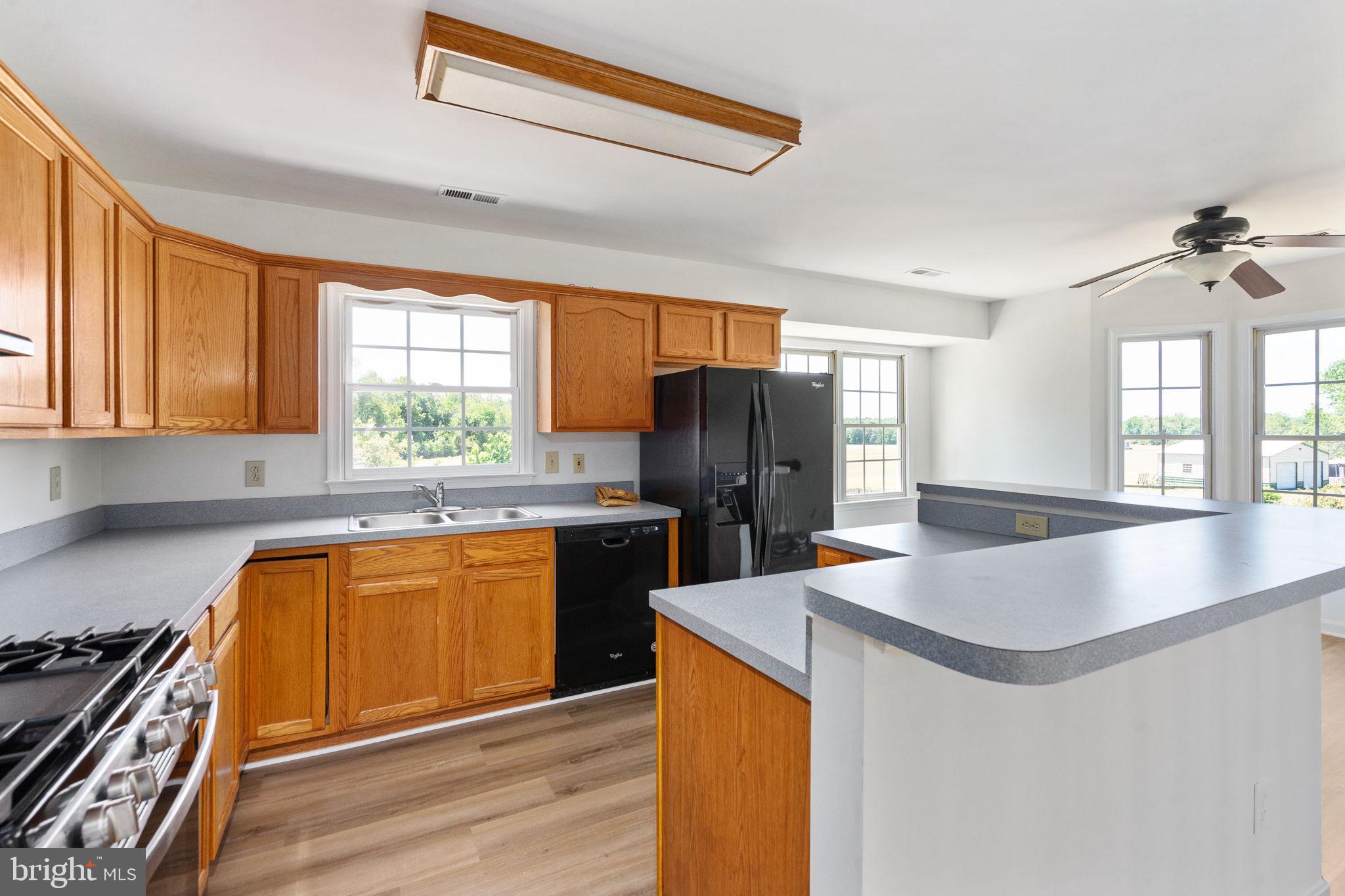 16456 Antioch Road Milford, VA 22514 - Photo 21 of 27 a kitchen with stainless steel appliances granite countertop a sink stove and refrigerator