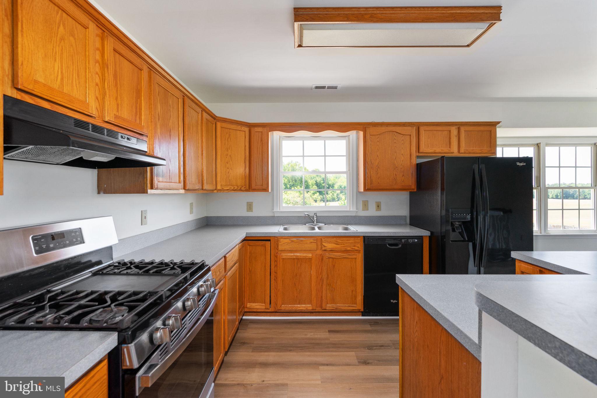16456 Antioch Road Milford, VA 22514 - Photo 22 of 27 a kitchen with granite countertop a refrigerator stove and sink
