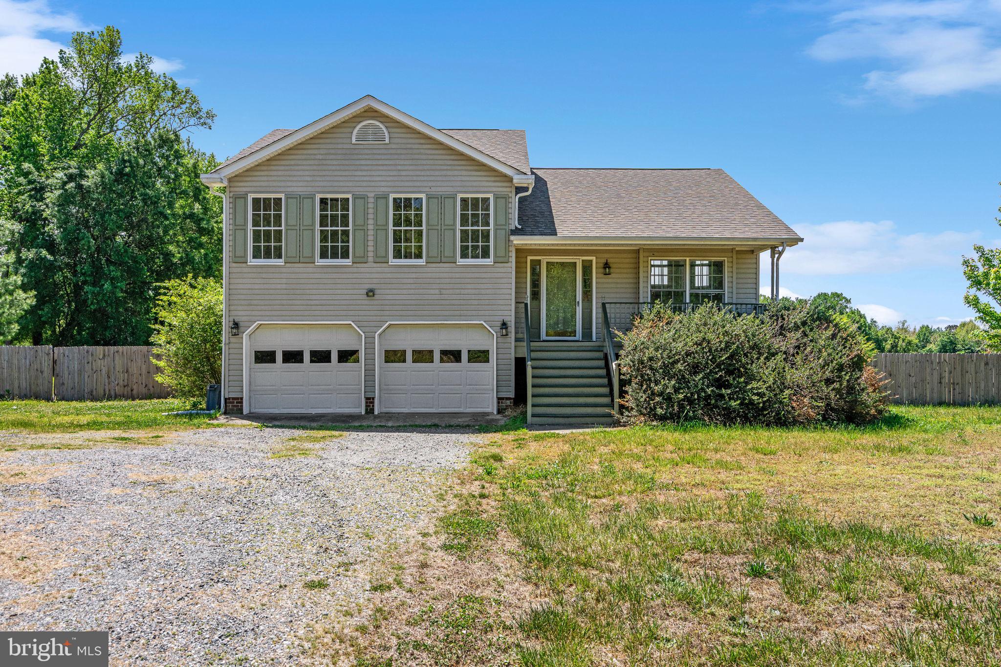 16456 Antioch Road Milford, VA 22514 - Photo 3 of 27 a front view of a house with a yard and garage