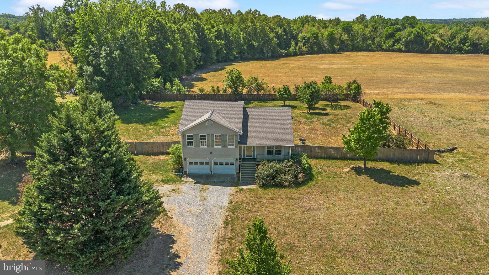 16456 Antioch Road Milford, VA 22514 - Photo 4 of 27 a view of a lake with a house in the background