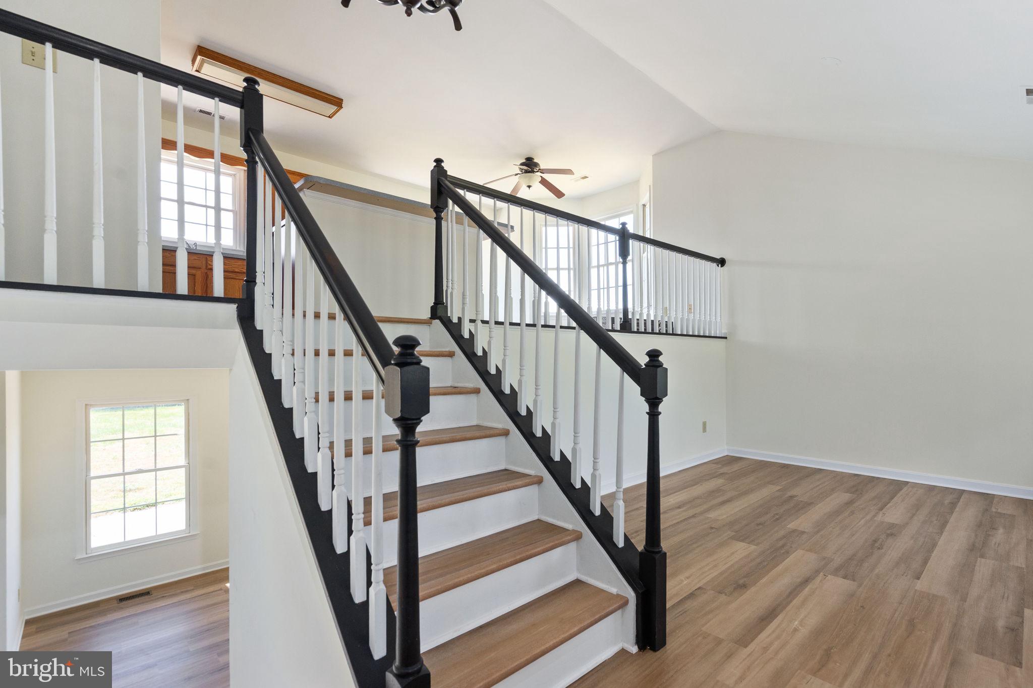 16456 Antioch Road Milford, VA 22514 - Photo 7 of 27 a view of staircase with wooden floor and white walls