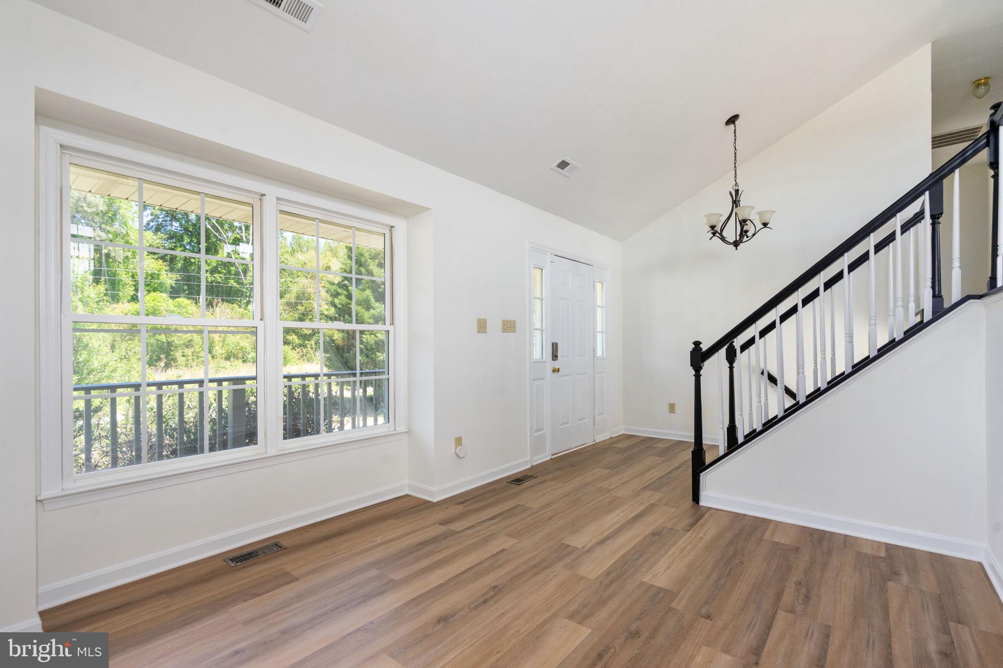 16456 Antioch Road Milford, VA 22514 - Photo 8 of 27 a view of an empty room with wooden floor and fan