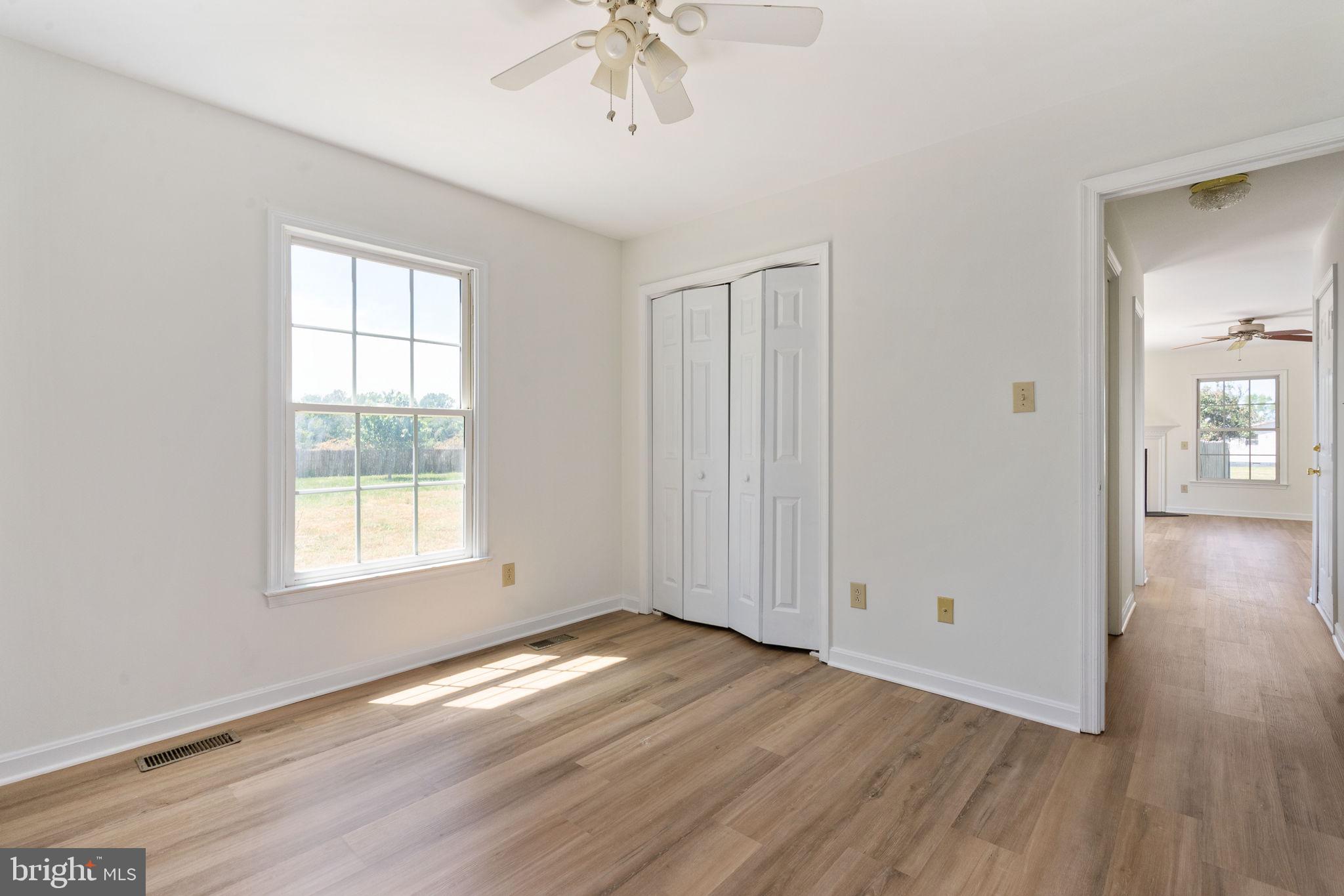 16456 Antioch Road Milford, VA 22514 - Photo 10 of 27 a view of an empty room with wooden floor and a window
