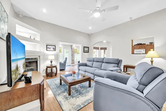 a living room with furniture a fireplace and a flat screen tv