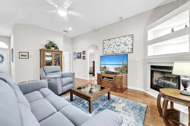 a living room with furniture a rug and a window