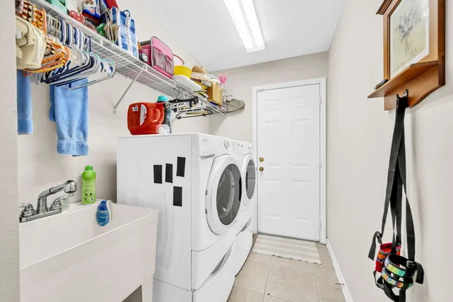 a spacious bedroom with a bed and a chandelier