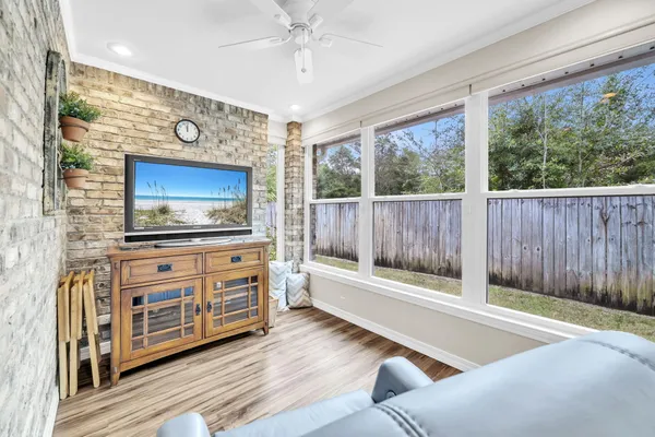 a living room with furniture and a floor to ceiling window