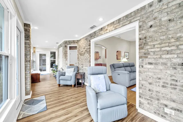 a living room with furniture wooden floor and a potted plant