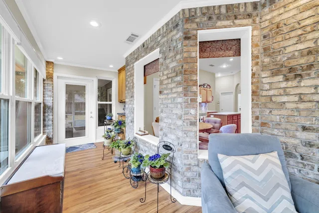 a living room with stainless steel appliances furniture and a kitchen