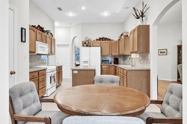 a kitchen with stainless steel appliances granite countertop a sink and cabinets