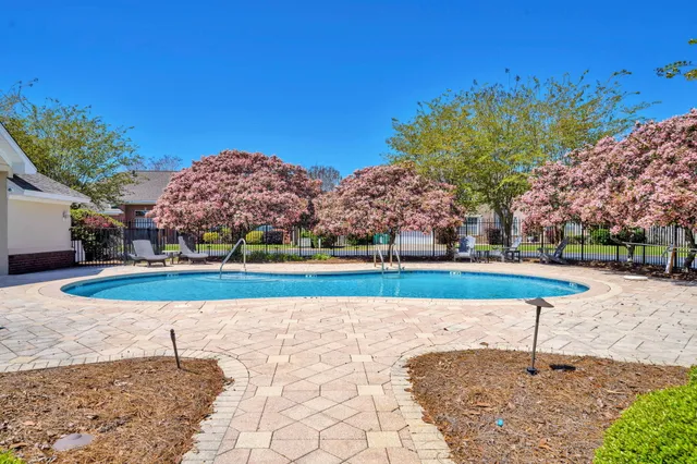 a view of a house with swimming pool and sitting area
