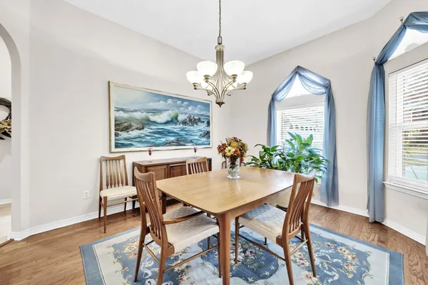 a view of a dining room with furniture and chandelier