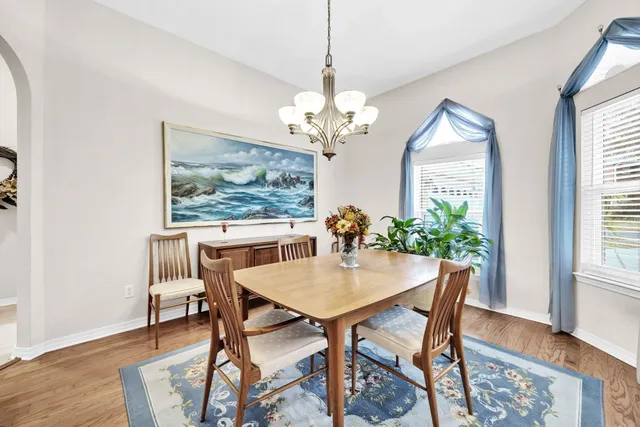 a view of a dining room with furniture and chandelier