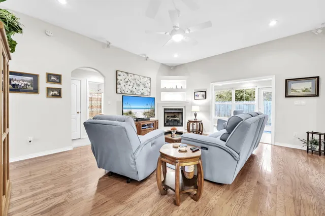 a living room with furniture flat screen tv and a fireplace
